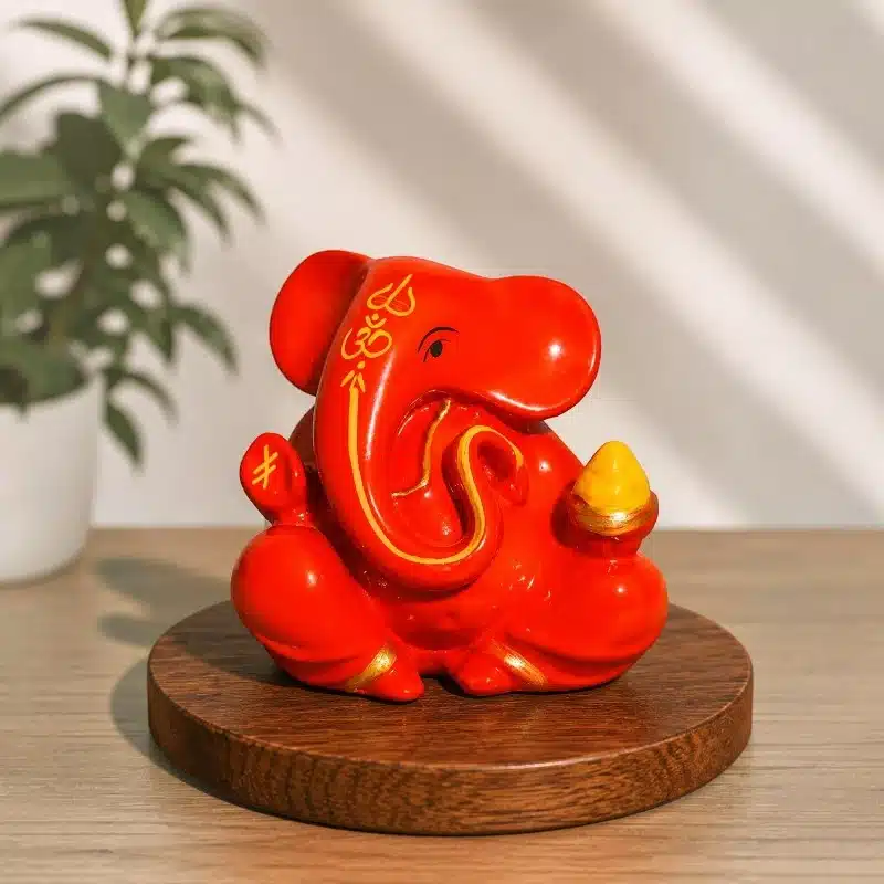 Orange Dashboard Ganesha Idol – Small Ganesh Ji for Car 1 Orange Dashboard Ganesha Idol